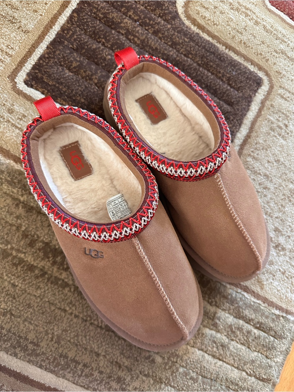 UGG Chestnut Suede Shearling-Lined Slip-Ons with Red Trim